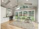 Sunlit living space with vaulted ceilings, skylights, patio access, and modern furnishings at 5164 E Princeton Ave, Cherry Hills Village, CO 80113