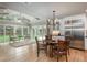 Bright living area with high ceilings, large windows, a dining area and hardwood floors at 5164 E Princeton Ave, Cherry Hills Village, CO 80113