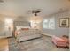 Bright main bedroom offers a plush bed, stylish seating, large windows, and decorative rug at 5164 E Princeton Ave, Cherry Hills Village, CO 80113