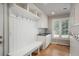 This well-organized mudroom features a bench, coat hooks, storage cabinets, and a convenient sink for added functionality at 5164 E Princeton Ave, Cherry Hills Village, CO 80113