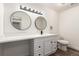 Modern bathroom with white cabinets, double vanity, and subway tile shower at 50 E Highline Cir # 102, Centennial, CO 80122