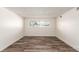 Simple bedroom with wood-look floors and large window at 50 E Highline Cir # 102, Centennial, CO 80122