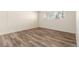 Spacious bedroom featuring wood-look floors and large window at 50 E Highline Cir # 102, Centennial, CO 80122