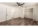 Bright bedroom with ceiling fan, closet, and wood-look flooring at 50 E Highline Cir # 102, Centennial, CO 80122