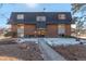 Brick building exterior with landscaping and walkway at 50 E Highline Cir # 102, Centennial, CO 80122