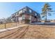 Two-story building exterior with walkway and landscaping at 50 E Highline Cir # 102, Centennial, CO 80122