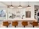 Modern kitchen with white cabinets, quartz countertops, and island with seating at 5125 Vivian St, Wheat Ridge, CO 80033