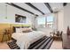 Bright and airy main bedroom with a mustard yellow accent wall at 5125 Vivian St, Wheat Ridge, CO 80033