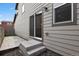 A back patio with a sliding glass door and stairs leading to the yard at 4770 N Jasper St, Denver, CO 80239