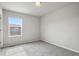 Clean and bright bedroom with neutral carpet, paint, and a window at 4770 N Jasper St, Denver, CO 80239