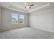 Spacious bedroom featuring plush carpeting, ceiling fan, and large windows for ample natural light at 4770 N Jasper St, Denver, CO 80239