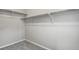 An empty walk-in closet featuring upper shelving and neutral carpeting at 4770 N Jasper St, Denver, CO 80239