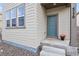 Welcoming front entryway with stylish blue door and decorative pot with flowers at 4770 N Jasper St, Denver, CO 80239