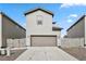 Two-story home with neutral siding, a two car garage, and a concrete driveway at 4770 N Jasper St, Denver, CO 80239