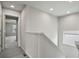 Upstairs hallway featuring modern lighting, neutral walls, and plush carpeting, leading to bedrooms and bathrooms at 4770 N Jasper St, Denver, CO 80239