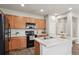 Well-equipped kitchen with wooden cabinetry, black appliances, and a functional island at 4770 N Jasper St, Denver, CO 80239