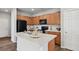 Functional kitchen showcasing wood cabinets, black appliances, and a convenient center island at 4770 N Jasper St, Denver, CO 80239
