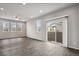 Bright, spacious living room featuring sleek wood floors and sliding glass doors to patio at 4770 N Jasper St, Denver, CO 80239