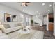 Bright, open-concept living room with hardwood floors, neutral palette, and ample natural light at 4770 N Jasper St, Denver, CO 80239