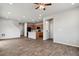 Open-concept living area showcasing hardwood floors, stairs, and adjacent kitchen with island at 4770 N Jasper St, Denver, CO 80239