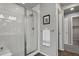 Modern bathroom shower with glass door, white tile, and stylish fixtures, adding to the spa-like retreat at 4770 N Jasper St, Denver, CO 80239