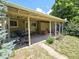 Backyard exterior view with covered patio, grass, trees, and blue sky at 1245 S Forest St, Denver, CO 80246