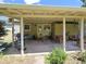 A covered patio complete with outdoor furniture in a grassy backyard at 1245 S Forest St, Denver, CO 80246