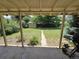 Covered patio with backyard access, featuring grass, trees, and a shed at 1245 S Forest St, Denver, CO 80246