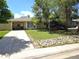 Charming single-story home featuring a well-maintained lawn, mature trees, and a welcoming front porch with seating at 1245 S Forest St, Denver, CO 80246