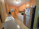Functional kitchen with stainless steel appliances, laundry, and ample cabinet space at 1245 S Forest St, Denver, CO 80246