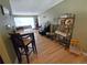 Open-concept living area with dining table, piano, hardwood floors, and natural light at 1245 S Forest St, Denver, CO 80246