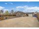 Full view of backyard with concrete parking pad, wood fence, and detached garage at 235 N 7Th Ave, Brighton, CO 80601