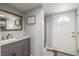 Bathroom featuring modern vanity, walk-in shower, and a well-lit mirror at 235 N 7Th Ave, Brighton, CO 80601