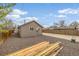 Exterior view of back of home, gravel yard, and fenced area at 235 N 7Th Ave, Brighton, CO 80601