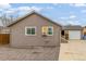 Back exterior of home with gravel yard, siding, and detached garage at 235 N 7Th Ave, Brighton, CO 80601