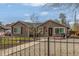 Charming home showcasing a walkway to the front door, a small lawn, and wrought iron fencing at 235 N 7Th Ave, Brighton, CO 80601