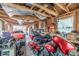 Large garage interior with a car and motorcycle, featuring exposed rafters and storage at 235 N 7Th Ave, Brighton, CO 80601