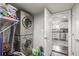 Convenient laundry area with stacked washer and dryer, shelves, and storage space at 235 N 7Th Ave, Brighton, CO 80601