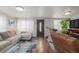 Inviting living room boasts hardwood floors, neutral paint, plenty of natural light, and modern furnishings at 235 N 7Th Ave, Brighton, CO 80601