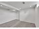 Finished basement features neutral carpet, recessed lighting, and freshly painted white walls at 3001 Fairfax St, Denver, CO 80207