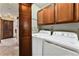 Laundry room with washer, dryer, and built-in cabinetry at 127 S Eagle Cir, Aurora, CO 80012