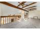 Open loft area with exposed beams, two ceiling fans, and plenty of natural light at 127 S Eagle Cir, Aurora, CO 80012