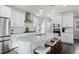 Modern kitchen featuring white cabinets, stainless steel appliances, and an island with seating at 5671 N Emporia St, Denver, CO 80239