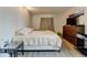 Bedroom with light hardwood floors, a large window, and a dresser at 8600 E Alameda Ave # 17-105, Denver, CO 80247