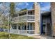 Exterior of blue two-story condo featuring private balcony with white railing and stone accents at 8600 E Alameda Ave # 17-105, Denver, CO 80247