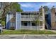 Two-story condo with blue siding and stone accents, featuring a private balcony and reserved parking space at 8600 E Alameda Ave # 17-105, Denver, CO 80247