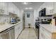 Modern galley kitchen featuring white cabinets, stainless steel appliances, and updated countertops at 8600 E Alameda Ave # 17-105, Denver, CO 80247
