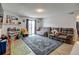 Bright living room with hardwood floors, large sofa, and sliding glass door leading to a balcony at 8600 E Alameda Ave # 17-105, Denver, CO 80247