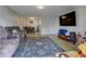 Cozy living room with hardwood floors, a large sofa, and a view into the dining area and kitchen at 8600 E Alameda Ave # 17-105, Denver, CO 80247