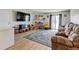 Spacious living room with hardwood floors, a fireplace, and a sliding glass door leading to a balcony at 8600 E Alameda Ave # 17-105, Denver, CO 80247